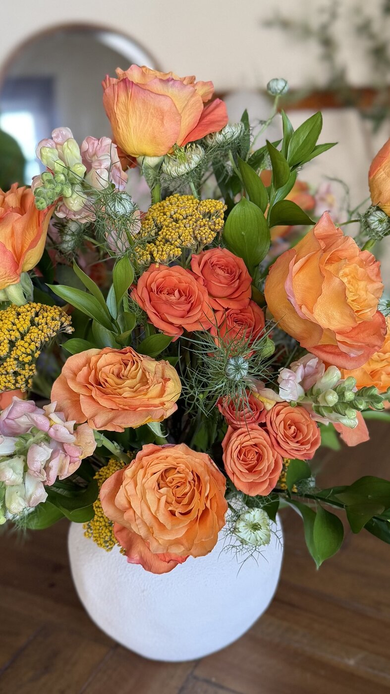 Close-up of peach roses and yarrow in an arrangement
