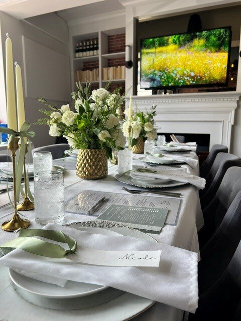 Place setting with a gold vase of white florals at The Poynt