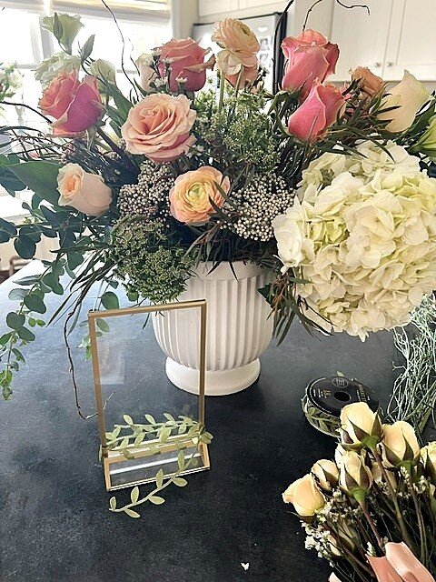 Pink and white arrangement in a white fluted vase